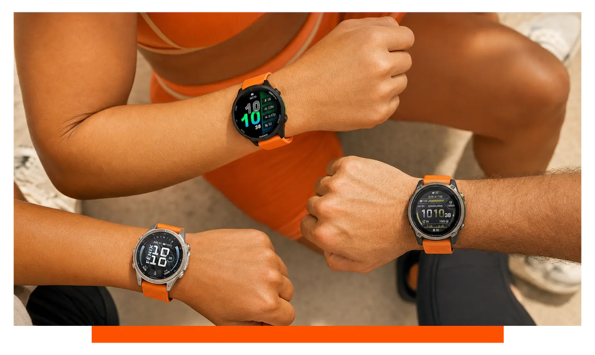 Three smartwatches worn on separate wrists, worn, mid-workout - Garmin Forerunner 970 and Garmin Fenix 9 and Garmin Enduro 4