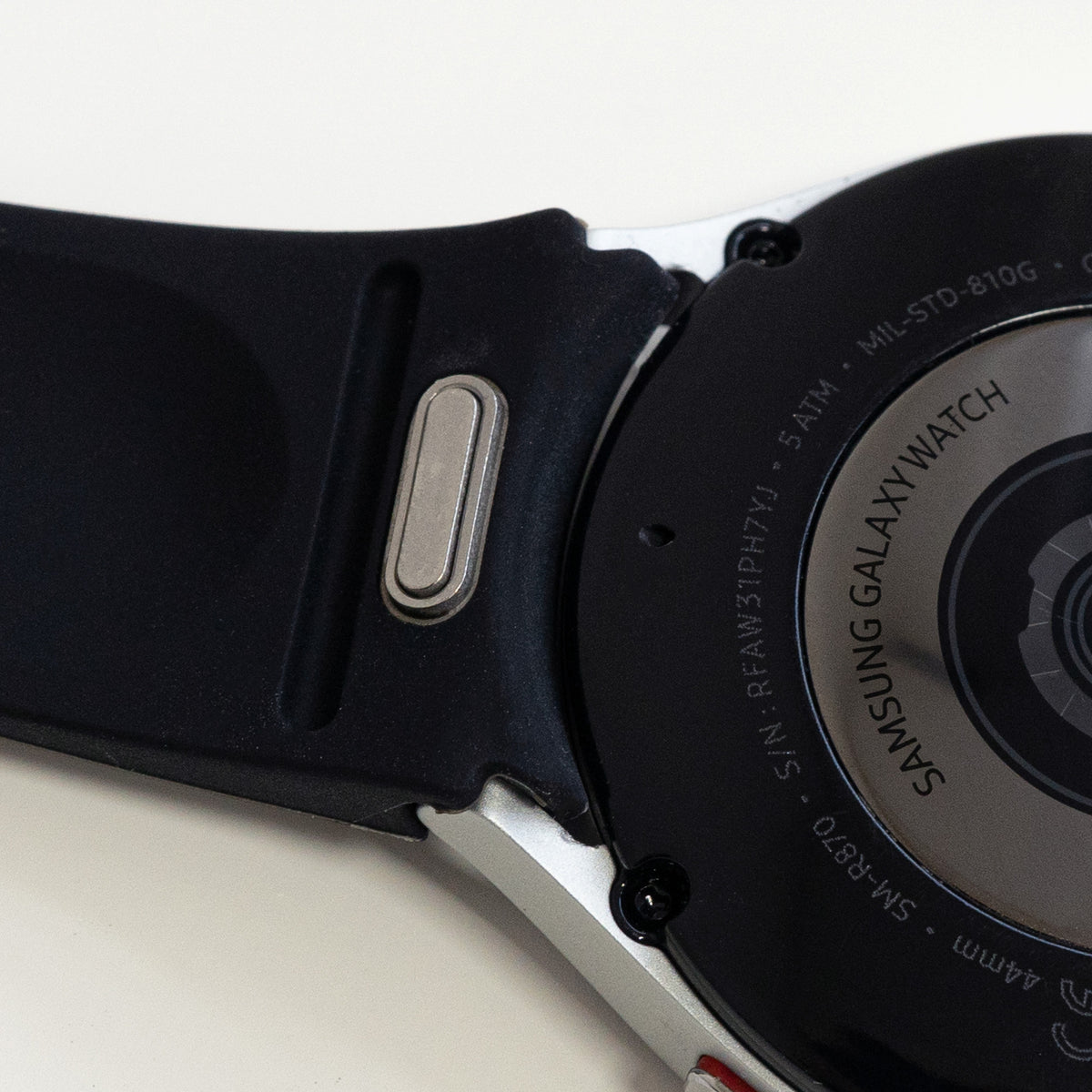 Silicone Strap 'One Push', black, on a watch, 3/4 rear view