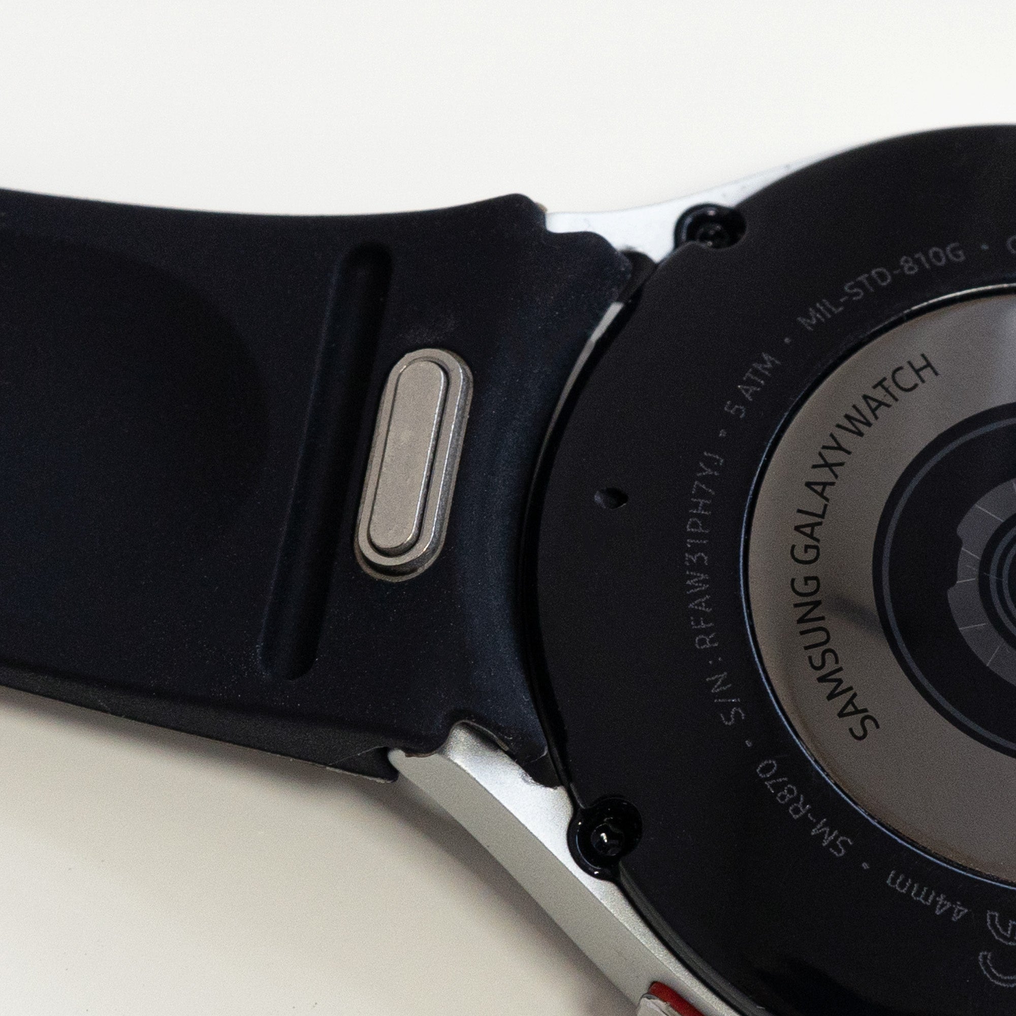 Silicone Strap 'One Push', black, on a watch, 3/4 rear view